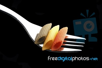 Italian Penne Pasta On A Fork Stock Photo