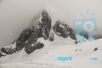 Jade Dragon Snow Mountain With Cloudy In Lijiang ,china Stock Photo