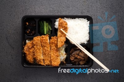 Japanese Food Tonkatsu Rice And Vegetable Take Away On Table Background Stock Photo