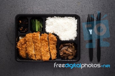 Japanese Food Tonkatsu Rice And Vegetable Take Away On Table Background Stock Photo