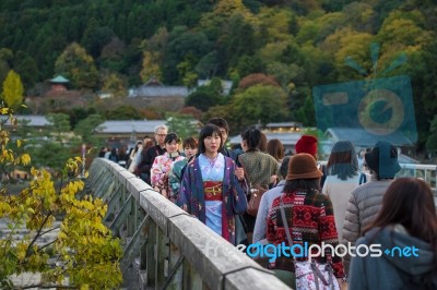 Japanese Girl On Togetsukyo Bridge, Arashiyama Stock Photo