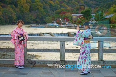 Japanese Girls Taking Photo At Togetsukyo Bridge Stock Photo