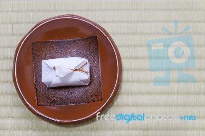 Japanese Traditional Dessert In White Paper Wrap With Red Rope Stock Photo