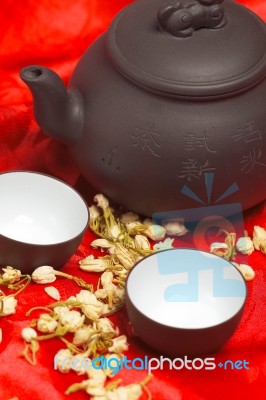 Jasmine Tea Over Red Silk Stock Photo