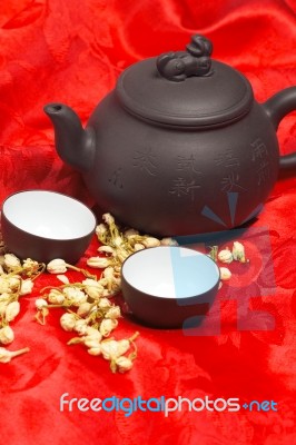 Jasmine Tea Over Red Silk Stock Photo