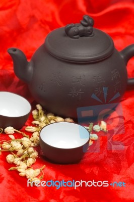 Jasmine Tea Over Red Silk Stock Photo