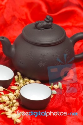 Jasmine Tea Over Red Silk Stock Photo