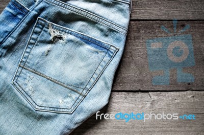 Jeans Lack On The Wooden Floor Stock Photo