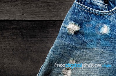 Jeans Lack On The Wooden Floor Stock Photo