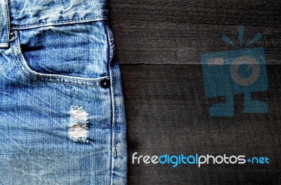 Jeans Lack On The Wooden Floor Stock Photo