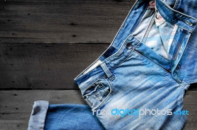 Jeans Lack On The Wooden Floor Stock Photo