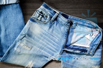 Jeans Lack On The Wooden Floor Stock Photo