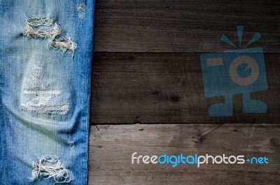 Jeans Lack On The Wooden Floor Stock Photo