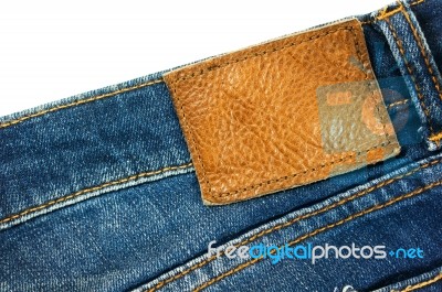 Jeans With Brown Leather Label On White Stock Photo