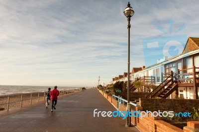 Joggers On Promenade At Bexhill On Sea Stock Photo