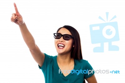 Jolly Female Model Pointing At Something Stock Photo