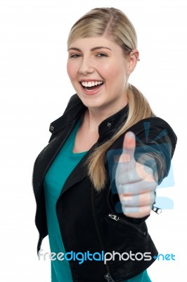 Joyful Blonde Teen Gesturing Thumbs Up Stock Photo