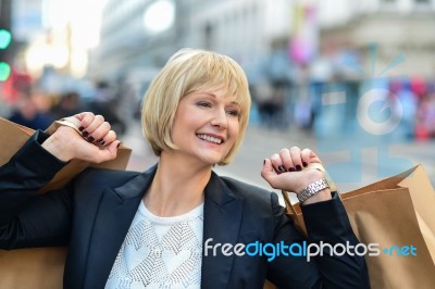 Joyful Businesswoman Holding Shopping Bags Stock Photo