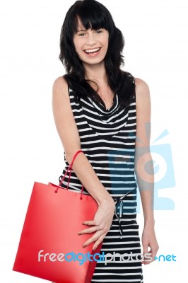 Joyous Brunette Posing With Red Shopping Bag Stock Photo