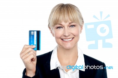 Joyous Female Employee Showing Credit Card Stock Photo