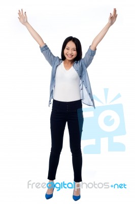 Joyous Female Raising Arms In Excitement Stock Photo