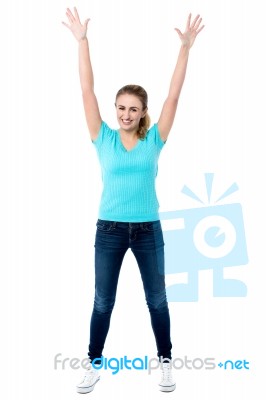 Joyous Female Raising Arms In Excitement Stock Photo