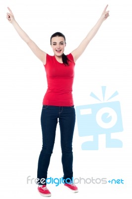 Joyous Female Raising Arms In Excitement Stock Photo