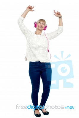 Joyous Middle Aged Woman Dancing To The Beat Stock Photo