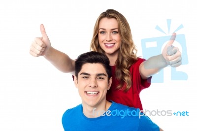 Joyous Woman Enjoying Piggy Ride And Showing Double Thumbs Up Stock Photo