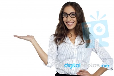 Joyous Woman In Spectacles Posing With Open Palm Stock Photo