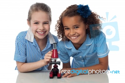 Joyous Young School Girls With Microscope Stock Photo