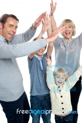 Jubilant Family Celebrating And Partying Indoors Stock Photo