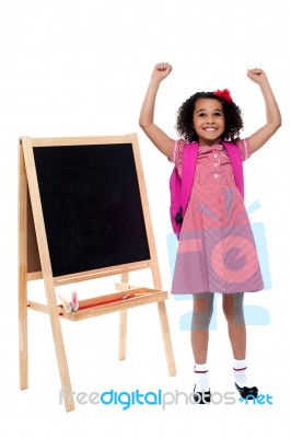 Jubilant Little Girl In School Uniform Stock Photo