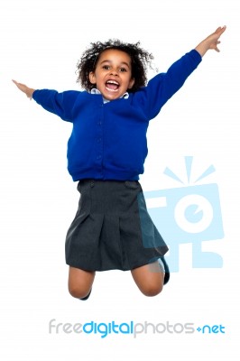 Jubilant School Kid Jumping High Up In The Air Stock Photo