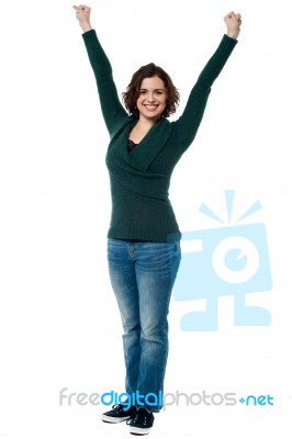 Jubilant Woman With Raised Arms Celebrating Victory Stock Photo