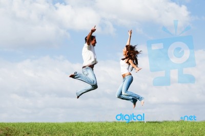 Jumping Joyful Couple Stock Photo