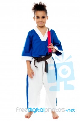 Karate Girl Holding Nunchucks Stock Photo