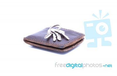 Key On Brown Wallet With White Background Stock Photo