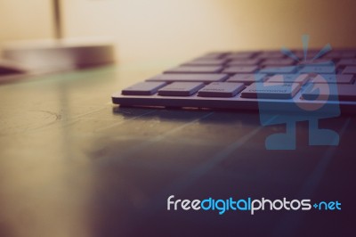 Keyboard Sitting On A Cutting Matt With Light In The Background Stock Photo