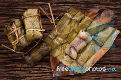 Khao Tom Mat - Thai Dessert - Sticky Rice, Banana And Black Beans Wrapped In Banana Leaf Stock Photo