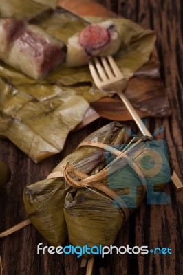 Khao Tom Mat - Thai Dessert - Sticky Rice, Banana And Black Beans Wrapped In Banana Leaf Stock Photo