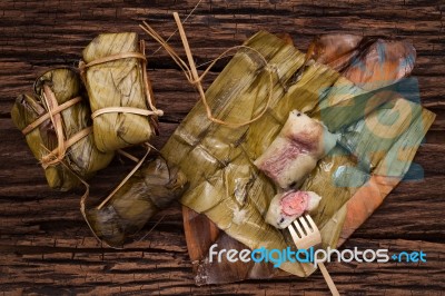 Khao Tom Mat - Thai Dessert - Sticky Rice, Banana And Black Beans Wrapped In Banana Leaf Stock Photo