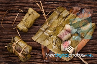 Khao Tom Mat - Thai Dessert - Sticky Rice, Banana And Black Beans Wrapped In Banana Leaf Stock Photo