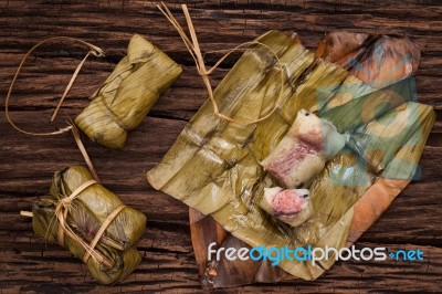 Khao Tom Mat - Thai Dessert - Sticky Rice, Banana And Black Beans Wrapped In Banana Leaf Stock Photo