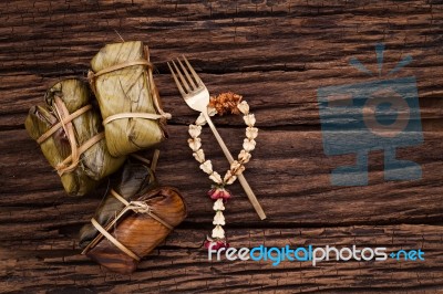 Khao Tom Mat - Thai Dessert - Sticky Rice, Banana And Black Beans Wrapped In Banana Leaf Stock Photo