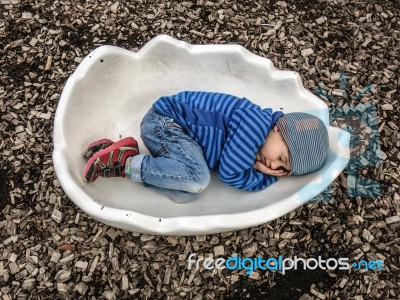 Kid In Eggshell Stock Photo