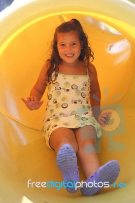 Kid Slipping Down Slide Stock Photo