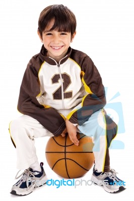 Kid Stylishly Sitting On The Ball Stock Photo