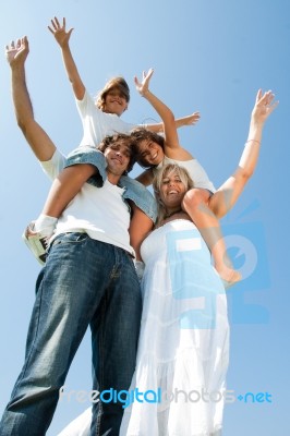 Kids ride on parents shoulder Stock Photo