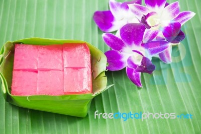 Kind Of Thai Sweetmeat, Multi Layer Sweet Cake (kanom Chan) On Banana Leaf With Orchid Flower Stock Photo